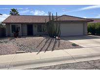 Charming single story home with desert landscaping and a two car garage at 2705 E Rock Wren Rd, Phoenix, AZ 85048