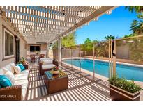 Inviting back patio under a pergola overlooking the pool and outdoor seating area perfect for entertaining at 2741 S Brooks --, Mesa, AZ 85202