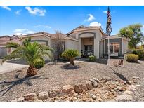 Charming single-story home with desert landscaping, palm trees and a welcoming facade at 3443 E Thornton Ave, Gilbert, AZ 85297