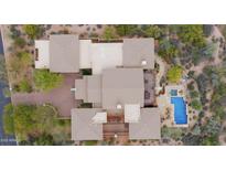 Breathtaking aerial view of luxury home featuring a sparkling pool and meticulously landscaped backyard at 36389 N 105Th Pl, Scottsdale, AZ 85262