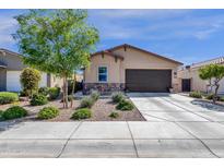 Charming single-story home featuring low maintenance desert landscaping, stone accents, and a spacious two-car garage at 4027 W Copperleaf Dr, San Tan Valley, AZ 85144