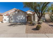 Charming single-story home featuring a well-maintained front yard with desert landscaping and a two-car garage at 4815 E Fernwood Ct, Cave Creek, AZ 85331