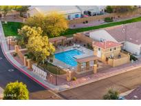 Beautiful community pool with seating and shaded areas for relaxation at 7010 W Downspell Dr, Peoria, AZ 85345
