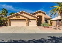 Charming single-Gathering home featuring a three-car garage and desert landscaping at 8402 W Laurel Ln, Peoria, AZ 85345