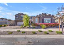 Beautiful two-story home featuring manicured landscaping and a charming stone facade at 9942 E Rotation Dr, Mesa, AZ 85212