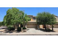 Charming two-story home with a two-car garage, well-maintained landscaping, and mature trees in a residential neighborhood at 1101 S Hazel St, Gilbert, AZ 85296