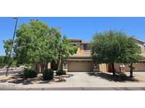 Well-maintained two-story home featuring a two-car garage and a driveway, surrounded by lush landscaping and blue sky at 1101 S Hazel St, Gilbert, AZ 85296