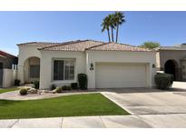 Charming single-story home with a two-car garage, desert landscaping, and a red tile roof at 11645 E Bella Vista Dr, Scottsdale, AZ 85259