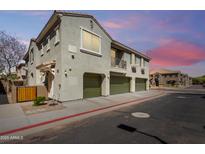 Multi-level home featuring a private garage, neutral stucco facade, and a small balcony under a twilight sky at 1330 S Aaron -- # 218, Mesa, AZ 85209