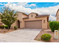 Charming single-story home with a neutral stucco exterior, a two-car garage, and low-maintenance landscaping at 1437 E Flamingo Way, Gilbert, AZ 85297