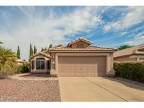 Charming single-story home featuring a two-car garage, tile roof, and well-maintained landscaping at 1439 S Dodge St, Gilbert, AZ 85233