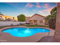 Inviting backyard pool with lounge seating and ample space for outdoor entertainment at sunset at 15206 S 47Th St, Phoenix, AZ 85044