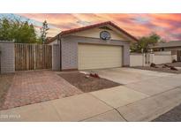 Charming home exterior featuring a two-car garage and basketball hoop at 1523 W Glenn Dr, Phoenix, AZ 85021