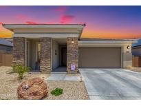 Charming home featuring a low maintenance yard, neutral colors, and a two car garage at 18956 W Laurel Ln, Surprise, AZ 85388