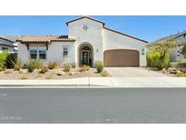 Beautiful single-Gathering home with a well-maintained xeriscaped front yard and an attached two-car garage at 22743 N 97Th Dr, Peoria, AZ 85383