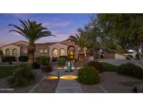 Charming single-story home with a tile roof, arched windows, lush landscaping, and inviting curb appeal at 24695 S 195Th Way, Queen Creek, AZ 85142