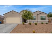 Charming single-story home features a low-maintenance desert landscape and a spacious two-car garage at 3818 N 306Th Ave, Buckeye, AZ 85396