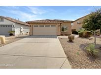 Single-Gathering home with a two-car garage and desert landscaping at 44271 W Oster Dr, Maricopa, AZ 85138