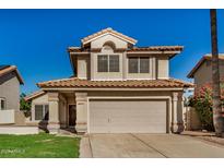 Two-story stucco home with a tile roof, two-car garage and manicured lawn at 6857 S Roosevelt St, Tempe, AZ 85283