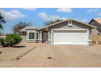Charming single-story home featuring a well-manicured gravel yard and a two-car garage, offering curb appeal and convenience at 7952 W Oregon Ave, Glendale, AZ 85303