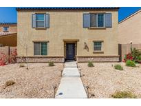 Inviting two-story home with neutral stucco and shutters and well-kept xeriscaped front yard at 8046 W Agora Ln, Phoenix, AZ 85043