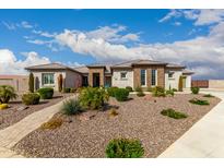 Stunning front exterior showcasing beautiful landscaping, a well-manicured yard, and inviting curb appeal at 216 W Paoli St, San Tan Valley, AZ 85143