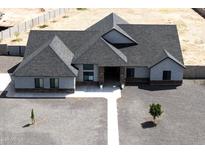 Expansive single-story home featuring a modern design, complemented by a durable roof and low-maintenance gravel landscaping at 34949 N Donald Way, San Tan Valley, AZ 85140