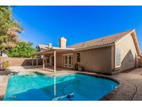 Sparkling backyard pool adjacent to a covered patio, offering a perfect oasis for relaxation and entertainment at 714 W Mesquite St, Gilbert, AZ 85233