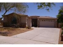 Charming single-story home featuring a stone facade, a two-car garage, and a well-manicured front yard at 2123 W Maldonado Rd, Phoenix, AZ 85041