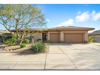 Charming single-story home featuring a two-car garage and desert landscaping at 7723 E Visao Dr, Scottsdale, AZ 85266