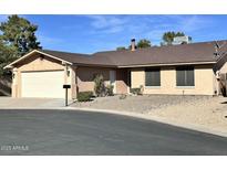 Charming single-story home with a two-car garage and low-maintenance desert landscaping in front at 10223 N 40Th Ave, Phoenix, AZ 85051