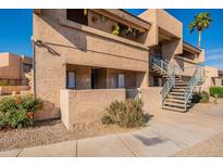 A view of the exterior of this multi-level townhome, complete with stairs to upper level units at 10828 N Biltmore Dr # 113, Phoenix, AZ 85029