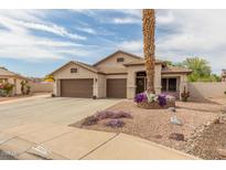 Charming single-story home features a three-car garage, desert landscaping, and a welcoming entrance at 14374 W Amelia Ave, Goodyear, AZ 85395