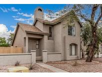 Charming stucco two-story home with a cozy front porch and well-maintained desert landscaping at 1535 N Horne -- # 35, Mesa, AZ 85203