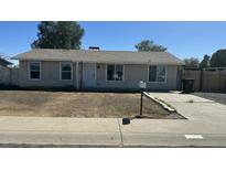 Charming single-story home with a well-maintained exterior and a partially xeriscaped front yard at 1615 W Michelle Dr, Phoenix, AZ 85023