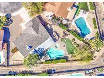 Aerial view of a beautifully landscaped home with a sparkling pool, spa, and inviting outdoor spaces at 1853 W Estrella Dr, Chandler, AZ 85224