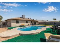 A refreshing backyard pool is surrounded by seating, perfect for enjoying sunny days at 2541 E Inverness Ave, Mesa, AZ 85204