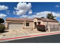 Charming single-story home featuring a two-car garage, desert landscaping, and a red tiled roof at 3310 E Fremont Rd, Phoenix, AZ 85042