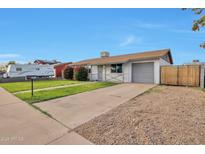 Charming single-story home with a well-manicured lawn, single car garage, and extended driveway at 3718 W Columbine Dr, Phoenix, AZ 85029