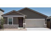 Charming single-story home with a two-car garage and stone accents, offering classic curb appeal at 5818 W Sunrise Dr, Laveen, AZ 85339