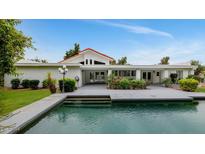 Stunning backyard view with pool and lush landscaping, perfect for outdoor entertaining at 7250 E Paradise Dr, Scottsdale, AZ 85260