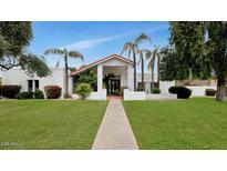 Charming home with well-maintained lawn, walkway, and mature landscaping at 7250 E Paradise Dr, Scottsdale, AZ 85260