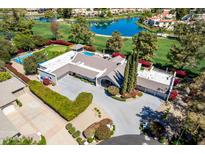 Stunning aerial view of luxury home with pool, putting green, tennis court, and water view in Scottsdale, Arizona at 87 Biltmore Est, Phoenix, AZ 85016