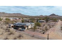 Spacious desert property with solar panels, covered parking, and fenced yard amid a scenic landscape at 31918 N 163Rd Ave, Surprise, AZ 85387