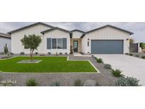 Charming home with a well-manicured lawn, stylish desert landscaping, and a modern exterior at 10907 W Woodruff Rd, Casa Grande, AZ 85194