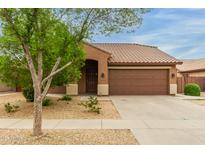 Charming single-story home featuring desert landscaping and a tile roof at 11277 W Buchanan St, Avondale, AZ 85323