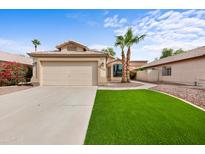 Charming single-story home with lush green lawn and desert landscaping with a two car garage and neutral color palette at 116 W Jasper Dr, Gilbert, AZ 85233