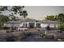 Stunning single-story home featuring a desert landscaped front yard and a welcoming entryway at 13947 E Barwick Dr, Scottsdale, AZ 85262