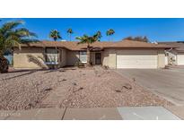Charming single-story home with low-maintenance desert landscaping, palm trees and a two car garage at 1716 N Temple St, Mesa, AZ 85203