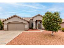 Charming single-story home with desert landscaping, inviting entrance, and two car garage at 2319 E San Tan Dr, Gilbert, AZ 85296